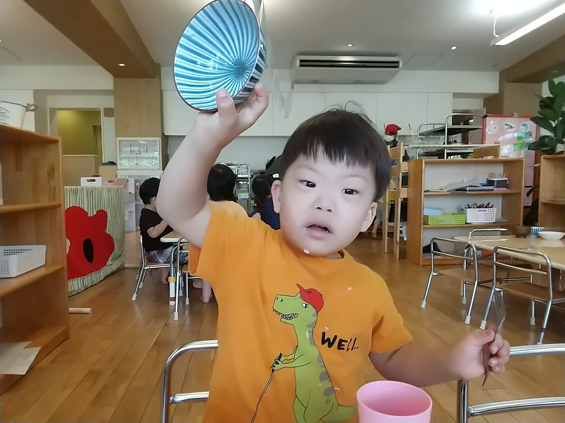 完食した食器を見せる子ども