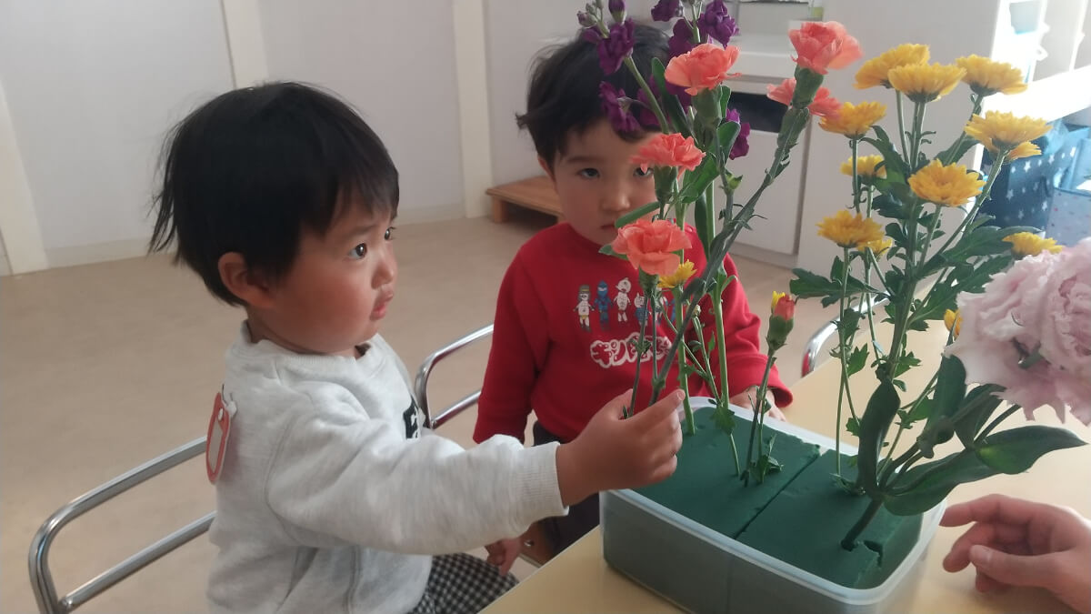 給水スポンジに花をさす子どもたち